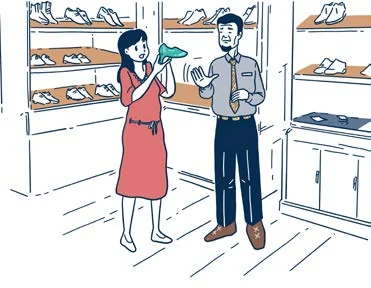 Un client essaie des chaussures dans un magasin.