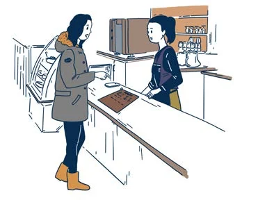 Une cliente passe commande dans un café.